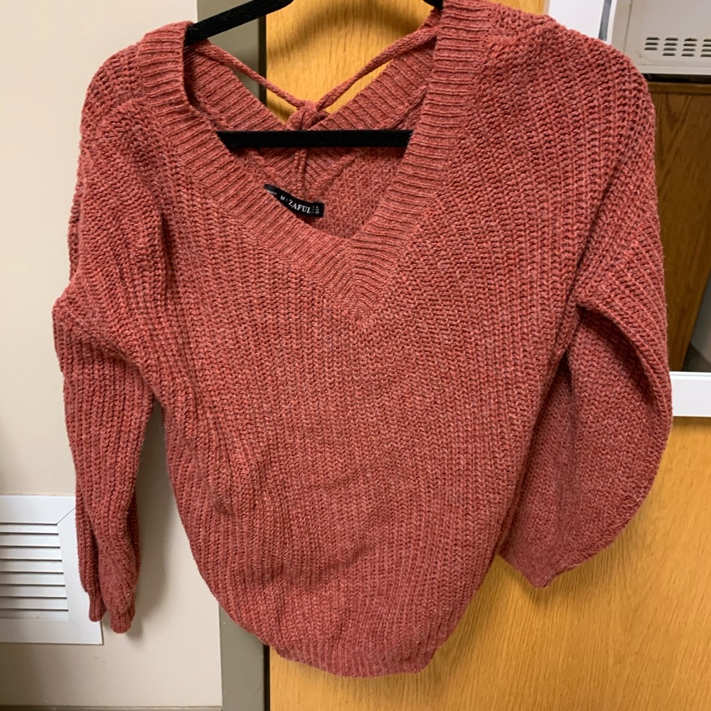 red/orange sweater with tie in back